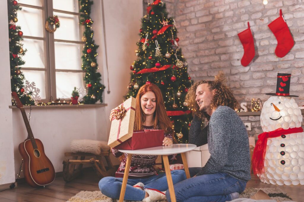 Couple opening presents on Christmas morning