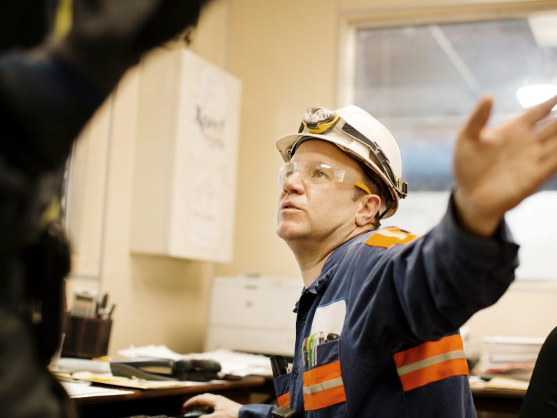 Side View Of Mature Male Worker Working In Office
